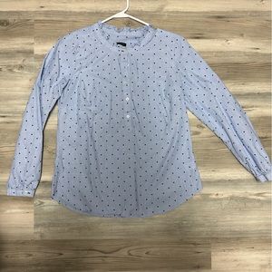 Blue polka dot shirt.